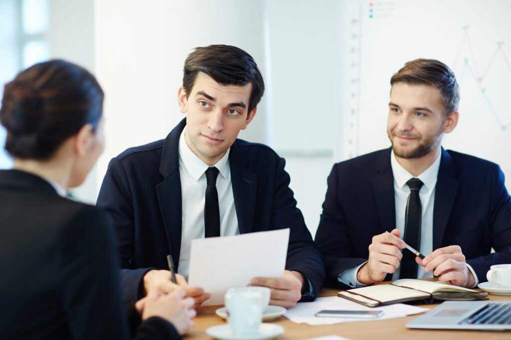 Professional panel conducting a job interview in a modern office setting, representing a company's strategic approach to hire top talent for key roles.
