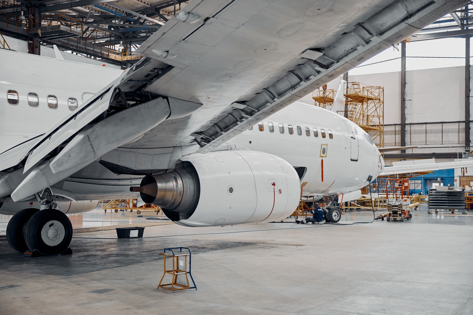 Aircraft undergoing maintenance in a streamlined facility, showcasing efficiency and precision aligned with lean manufacturing principles.