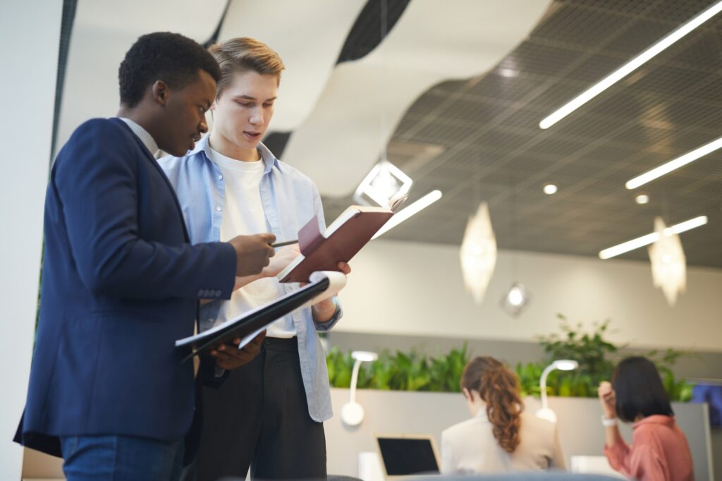 Two professionals reviewing documents in a modern office—illustrating collaboration, evaluation, and strategic planning aligned with top accounting recruitment tips. 