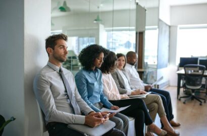 Applicants waiting outside of an office to be interviewed.