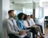 Applicants waiting outside of an office to be interviewed.